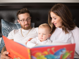 Photo of young parents reading a book